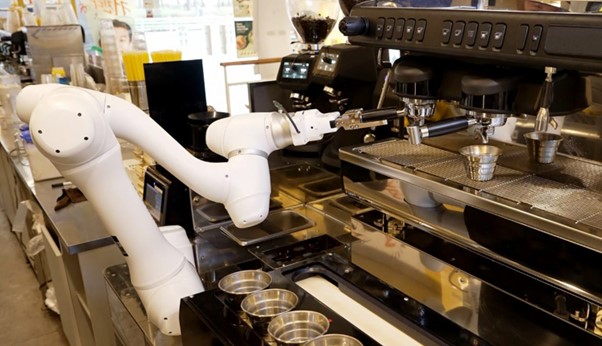 ▲ Doosan Robotics, collaborative robot is mounting a portafilter filled with ground coffee beans to a coffee machine.
